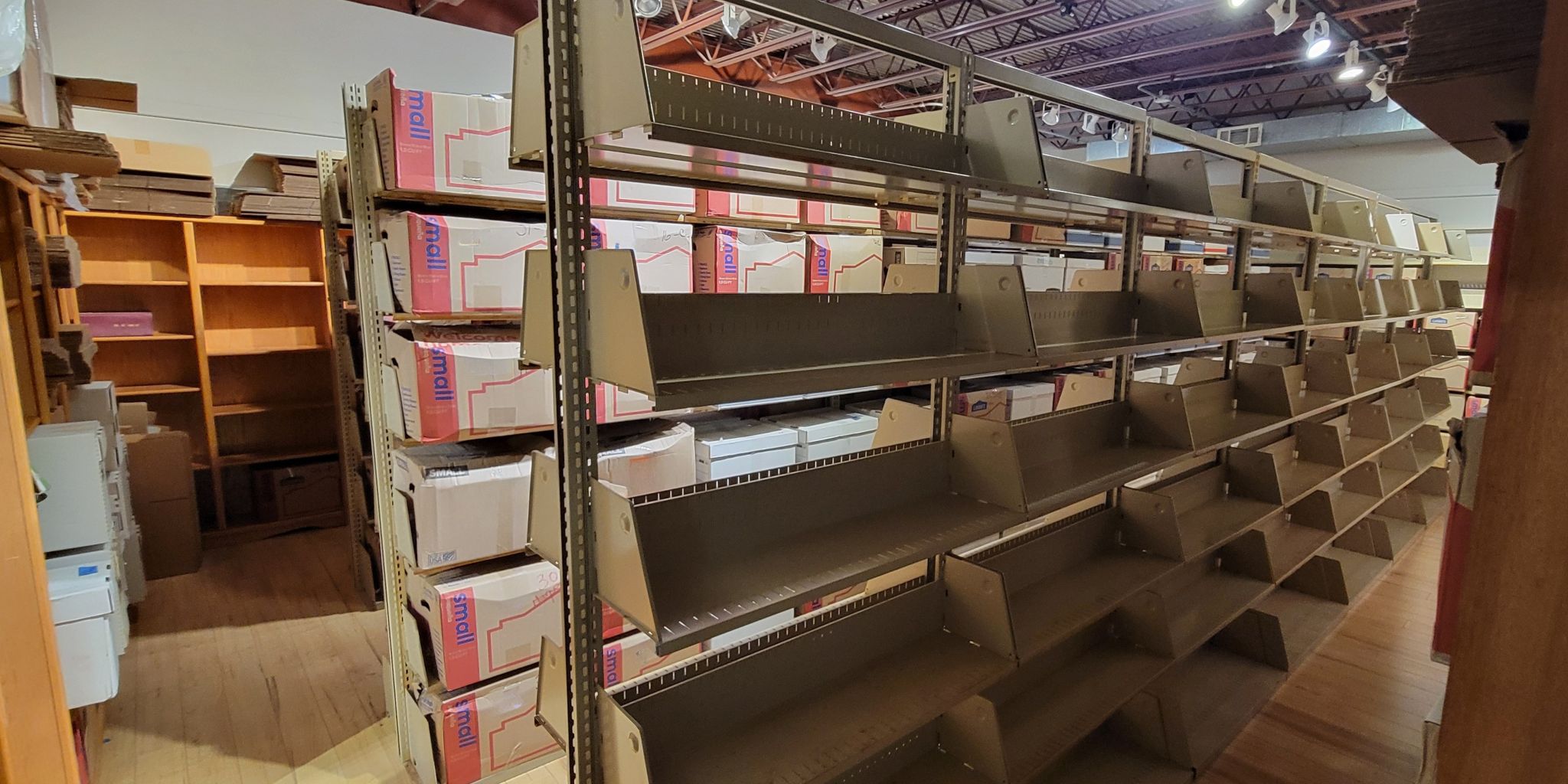 Rows of library shelving and boxes after a major collection arrived at Kansas Book Depository