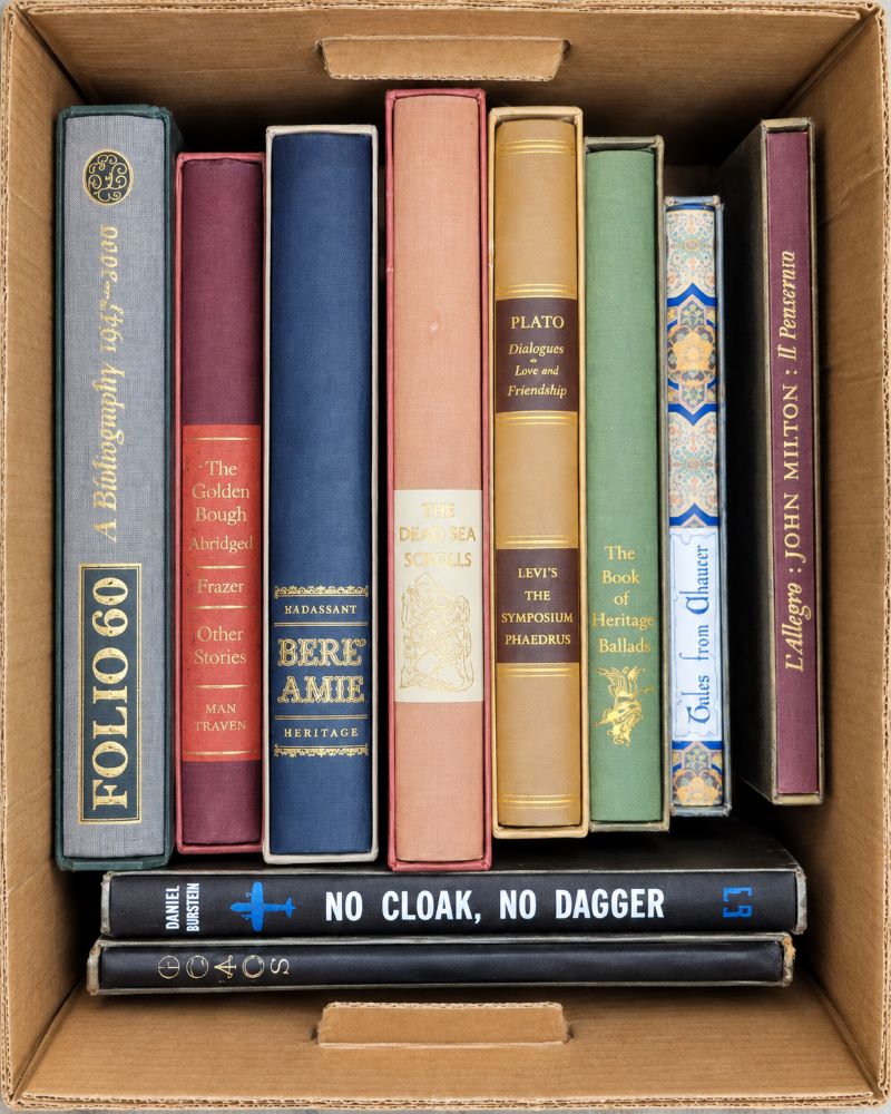 A box of books arranged with the spines and titles facing upward