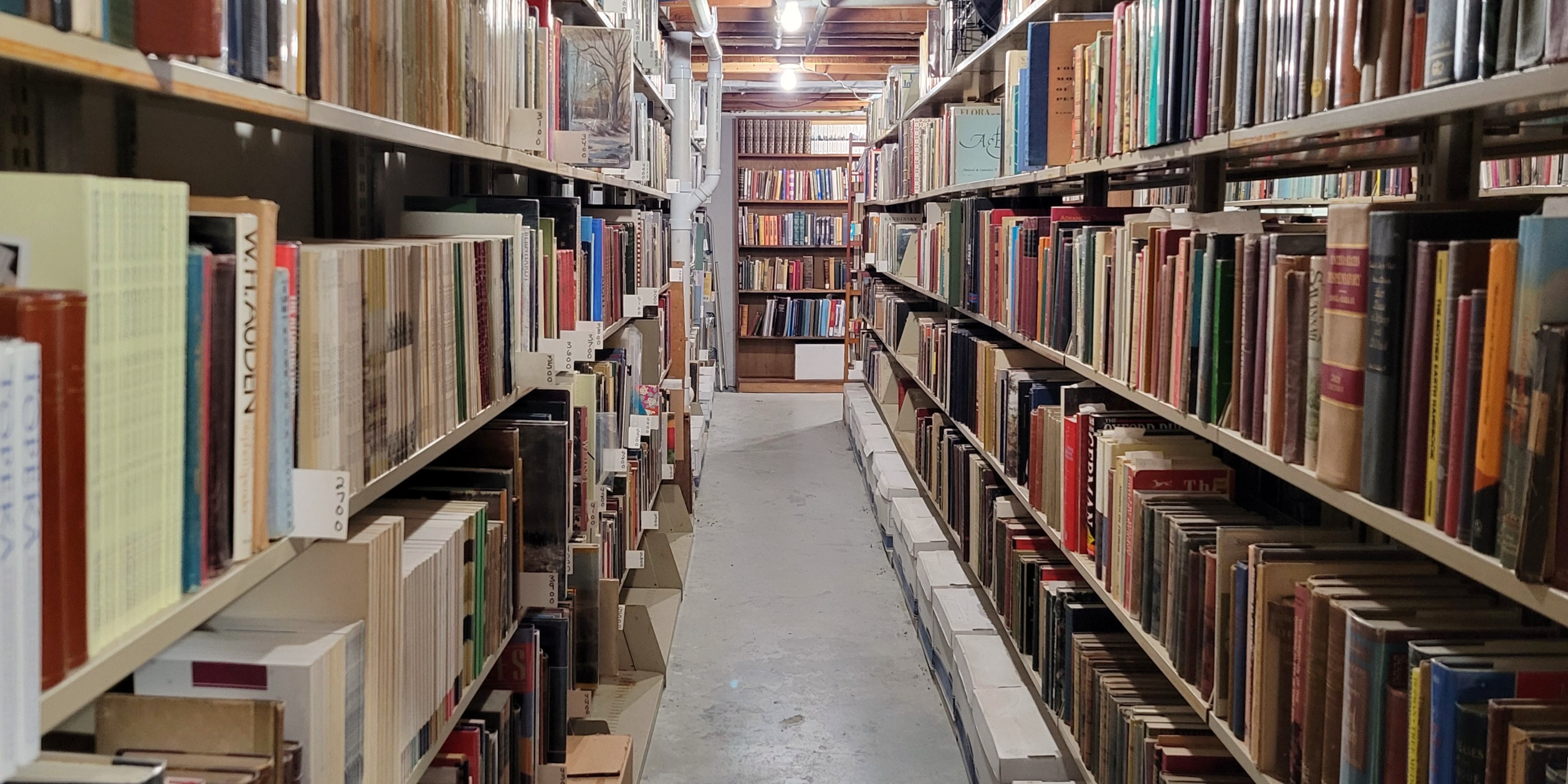 A long aisle of books on shelves at the Kansas Book Depository
